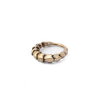 Introducing the AARO Cyborg Seamless Hoop Septum Nose Ring in Gold by Kaya Movement. This 18 gauge ring features a unique, segmented pattern that adds a textured and slightly rugged appearance. It boasts an antique finish and is elegantly displayed on a plain white background.