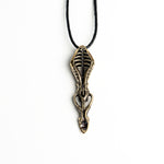 Long vertical brass spoon pendant with organic and mechanical elements, offering a blend of gothic and avant-garde style.