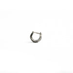 A close-up of a Silver 925 bioorganic septum clicker, featuring an intricate biomechanical-inspired design with a secure clicker closure, displayed on a clean white background.