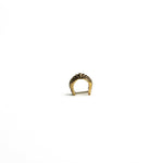 A front-angle view of a brass bio-organic septum ring with a clicker closure, showing its smooth curvature and antique finish.