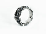 BIOORGA sterling silver biomechanical ring seen at a three-quarter angle, with polished ridges and dark recesses.