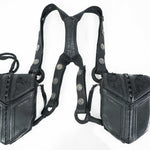 The KERO Unisex Lightweight Leather Holster Bag by Kaya Movement is a pair of black sheepskin leather suspenders with two pouches, perfect as Burning Man festival accessories. Each pouch features detailed stitching and embossed designs. Decorative metal studs are integrated into the straps, and the textured leather along with adjustable buckles ensures a perfect fit.