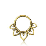 The gold MAWAR Lotus Flower Septum Ring in 18 gauge from Kaya Movement showcases a circular design accented by five petal-like extensions, each graced with delicate bead details. This finely crafted gold brass body jewelry boasts an antique finish, delivering a vintage and ornamental aesthetic.