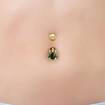 Close-up view of the LIOSA Marquise Belly Piercing Ring in Gold & Onyx by Kaya Movement, showcasing a gold stud and a decorative charm with a black teardrop-shaped stone framed by gold accents resembling rays or petals. The background displays smooth, bare skin. This elegant 14-gauge piece, ideal for gift packaging, combines beauty with surgical steel durability.
