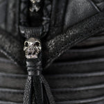 Close-up of the APOPHIS Post-Apocalyptic Leather Shoulder & Belt Bag by Kaya Movement, showcasing its detailed black leather finish with small silver skull embellishments. The texture of the leather is visible, featuring intricate stitching and design elements. The skull adds an apocalyptic touch that's perfect as a wasteland festival accessory.