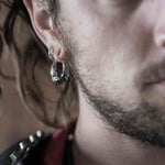 Single Xenomorph sterling silver hoop earring worn on the ear