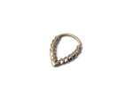 The KAMO Biomech Teardrop Septum Ring in Gold by Kaya Movement is a striking piece of jewelry, crafted from gold brass. It features a unique geometric design with connected hexagonal shapes forming a V-shape, making it stand out beautifully against a plain white background.