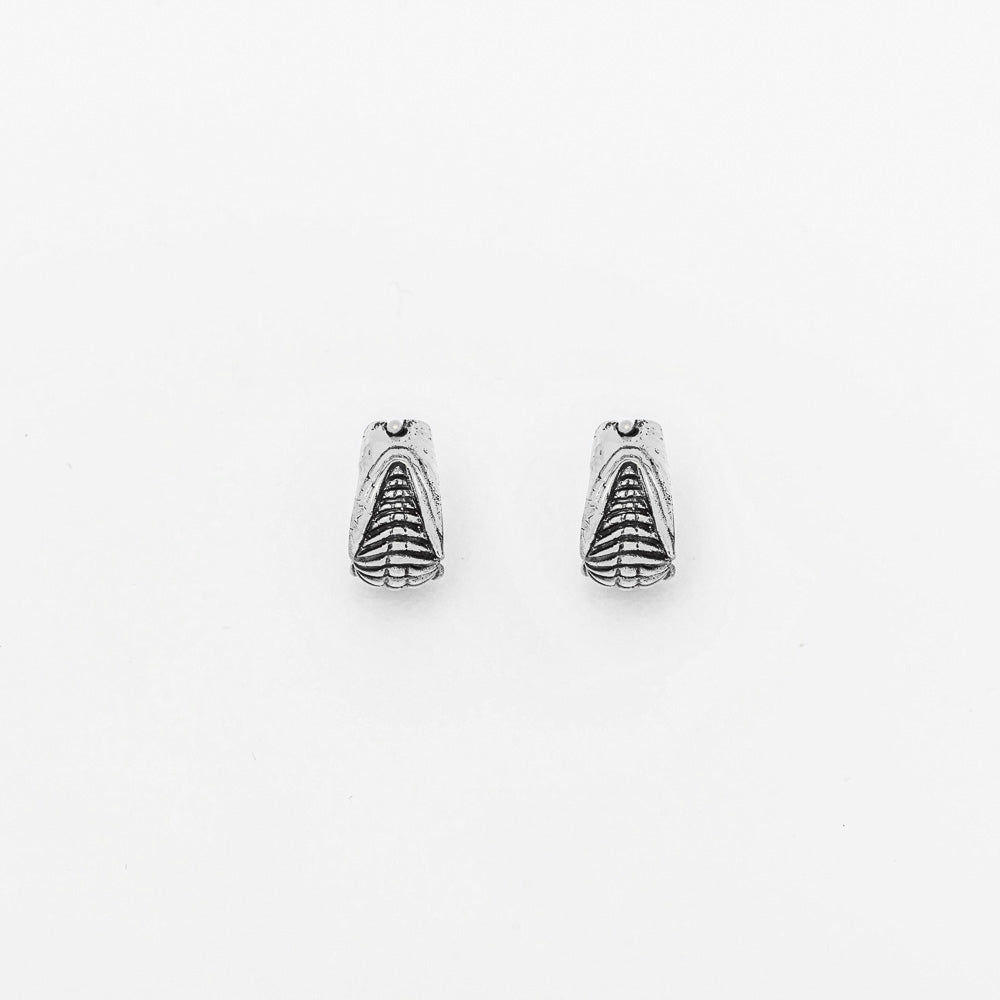 A Darma Biomechanical Clicker Hoop Septum Nose Ring in Silver, created by Kaya Movement, is displayed against a plain white background. This 16-gauge nose ring features an intricately designed insect-like appearance with fine detailing on its body and wings, reminiscent of post-apocalyptic body jewelry.