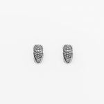 The Darma Biomechanical Clicker Hoop Septum Nose Ring in Silver by Kaya Movement features intricate, etched designs that evoke a post-apocalyptic body jewelry feel. The textured surface showcases horizontal and vertical lines creating a woven pattern. These 16-gauge unisex accessories are displayed side by side on a plain white background.