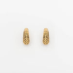 A pair of AARO Cyborg Clicker Hoop Ear or Septum Weights in Gold Brass from Kaya Movement, featuring intricate detailing and a textured surface reminiscent of scales or leaves. Set against a plain white background, these 6-gauge earrings are perfect for those with stretched ear piercings seeking unique body jewelry.
