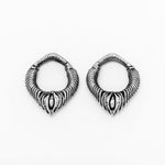 The MARVDASHT Small Biomechanical Clicker Ear Weights in 925 Silver by Kaya Movement, showcased against a white background, feature intricately designed hoops with a textured ribbed pattern tapering to a pointed tip. Their unisex gauge design and central marquise-shaped detail exude sci-fi vibes, enhancing their ornate appearance.
