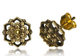 The ILLY Lotus Mandala Stud Earrings in Gold from Kaya Movement are intricately designed for ear lobe or conch helix piercings. Each 18g gauge earring showcases a delicate floral motif with petal details and a central bead, set against a reflective background that creates a mirrored effect on the white surface.