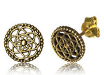 The ELLY Flower of Life Stud Earrings in Gold by Kaya Movement are crafted in yellow brass, featuring intricate openwork designs resembling atom or flower patterns. These circular earrings boast a beaded edge and a small central bead, with one earring facing front and the other showing the back and post. Perfect for ear lobe, conch, or helix piercings.