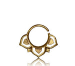 Introducing the TWIL Lotus Mandala Septum Ring in Gold by Kaya Movement, an 18 gauge septum ring featuring an intricate tribal ethnic Lotus design with heart and teardrop shapes. This circular-shaped ring has an opening at the top and boasts ornate details at the bottom, perfect for those who appreciate unique gold brass body jewelry.