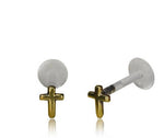 A pair of CROSS Labret Studs in Gold by Kaya Movement, featuring a minimalist cross design with transparent backings. These 16-gauge earrings are displayed against a white background, with one laying down and the other standing upright. Ideal for tragus, helix, or labret piercings.