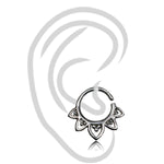 A black and white illustration of an ear is depicted with the KAAL Lotus Ring in Silver from Kaya Movement, a 20 gauge decorative hoop earring featuring an intricate floral design at the lower part of the 925 Sterling Silver body jewelry ring. The multi-use piercing is centered over the earlobe in the image.