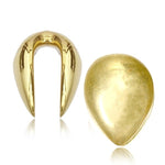 The image shows two gold-colored, brass metal clip-on ear cuffs from Kaya Movement against a white background. One ear cuff has a horseshoe shape with pointed ends, while the other is one of the OLO Minimalist Teardrop Ear Hangers in Gold. Both have a polished, reflective finish and measure at a 14mm gauge (5/8 or 9/16 gauge).