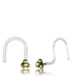 A pair of Kaya Movement's TRINITY Nose Screw Studs in Gold, each featuring a small trinity knot design at the end. The 20-gauge body jewelry is positioned with its decorative ends facing each other on a reflective white surface.