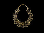 The Lotus Flower Pair Earrings from Kaya Movement feature intricate ornamental designs with circular patterns reminiscent of Mandala earrings and decorative detailing around the hoop, creating an elegant and ornate appearance. The solid black background beautifully highlights these handmade mandala brass jewelry pieces.