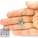 A hand holding a decorative piece of jewelry with a curved silver stem ending in a shiny ball. The pendant features intricate silver detailing and colored inlays. Perfect as sterling silver body jewelry, the "Kaya Movement" logo is visible in the bottom left corner. The piece is identified as the Belly Button Bar Shell Piercing Sterling Silver Navel Belly Piercing adorned with a magnificent Abalone - 14g - Short bar 9mm.