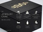 A black jewelry box adorned with an intricate gold design and the text "Kaya Movement" on the lid showcases a stunning Shipibo pendant from their Trippy jewelry collection. The image includes these jewelry care tips: Remove before showering, swimming, sauna, intense activities; avoid sleeping with jewelry; keep away from chemicals; store separately.