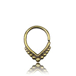 The LILY Seamless Teardrop Septum Ring in Gold by Kaya Movement features a beaded tribal design with small, evenly spaced beads along the lower curve. Displayed against a plain white background, the 18-gauge, gold-toned jewelry casts a slight shadow.