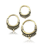 Three small BIASA Seamless Septum Rings in Gold by Kaya Movement are displayed. Each 16-gauge septum nose ring features intricate detailing with small, beaded designs along the lower half, giving them a traditional, ornate appearance. The rings are arranged in a triangular pattern on a white background.