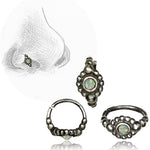 A drawing of a nose pierced with the SHA Beaded Flower Nose Ring in Silver & White Opal from Kaya Movement, featuring a natural white opal gemstone. Three detailed views of this 20-gauge multi-use piercing showcase its intricate design and opal centerpiece, displayed beside the drawing. The 925 silver body jewelry has a vintage, bohemian appearance.