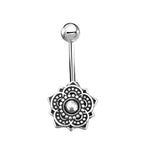 The Boho Short Belly Button Ring Curved Barbell by Kaya Movement is crafted from Silver 925 and features a stunning lotus flower design on one end with a central clear gemstone surrounded by circular and petal-shaped patterns, making it the perfect piece of ethnic body jewelry for navel piercings.