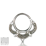 A Silver Lotus Flower 8mm Septum Ring from Kaya Movement features a mandala-inspired design with intricate geometric and dot patterns. This small silver hoop earring, an 18g size (1mm), showcases decorative triangular points on the bottom half, epitomizing silver body jewelry artistry.