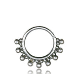 The BRAI Seamless Septum Ring in Silver by Kaya Movement is an 18-gauge silver hoop adorned with nine small, evenly spaced spherical beads on the outer edge, forming a decorative semicircle. This 925 silver body jewelry piece features a subtle tribal ethnic design against a plain white background.