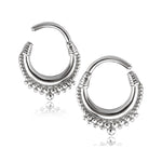 A pair of Silver Septum Ring Clicker Hinged Teardrop earrings, sized at 16g with an 8mm diameter, perfect for conch, daith, helix body piercings or cartilage earrings. Created by Kaya Movement, these silver pieces showcase intricate beaded detailing along the bottom edge. Inspired by small tribal surgical steel septum nose piercing rings, they feature a slightly textured finish near the closure and a dangling bead at the center of the trim. Displayed against a white background.