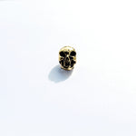 The Viking Hair Beads Accessories from Kaya Movement, featuring an intricately carved Alien Vampire Skull in metallic gold, make a perfect addition for adding a unique touch to dreadlocks. Placed on a white background, subtle shadows fall to the left and behind the charm.