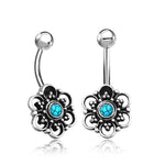 These Kaya Movement Turquoise Belly Rings are the epitome of elegance, featuring curved barbells with intricate lotus flower and mandala designs. Each ring boasts a small turquoise stone in the center, surrounded by delicate filigree detailing, making them perfect for any navel piercing.
