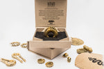 A stylish Oparis Septum in 925 Sterling Silver, featuring an intricate opal design, is displayed in an eco-friendly, open cardboard box emblazoned with the branded logo "Kaya Movement." The box is surrounded by various opal jewelry and gold-toned accessories, including snake and skull trinkets.