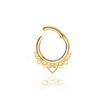 The Liora Minimalist Mandala-Inspired Septum by Kaya Movement boasts a gold hoop design with intricate heart-shaped and circular mandala patterns hanging from the bottom. Crafted from smooth, reflective 316L steel, this elegant piece is available in gauges of 1.2mm and diameters of 6mm, 8mm, and 10mm, casting a delicate shadow on the white background.
