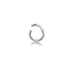 The Aurel Simple Ear Ring by Kaya Movement, crafted from 316L steel with a silver finish, boasts a smooth, polished surface and rests against a plain white background. Available in gauges of 2 or 3mm and diameters of 8, 10, 12, and 14mm, this small hoop earring features a hinged closure that exudes minimalist elegance while casting a faint reflection on the surface below.