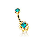 Introducing the Bohal Navel Jewelry by Kaya Movement: a stunning gold belly button ring crafted from 316L surgical steel with a curved bar. This piece showcases iridescent blue and green abalone shell accents on both ends, with the lower end encircled by small gold beads arranged like petals, epitomizing natural and bohemian elegance.