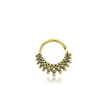 The Gold-Plated Brass Septum in Maya Tribal Design by Kaya Movement is a trendy and unique nose ring featuring a hoop design with intricate teardrop and small circular embellishments forming a semi-circle pattern at the bottom. Adorned with detailed golden leaf motifs, this piercing embodies vintage bohemian jewelry with its meticulous filigree work. Suitable for multiple piercings, including helix 1.2mm, tragus, lobe, and conch.