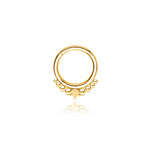 The Kaya Movement "Astria" Starry Bohemian Septum in 316L Gold PVD Steel features a gold circular hoop with a central star design. It includes progressively larger gold beads flanking the small star, creating a symmetrical celestial look. The earring has a Gold PVD finish and is displayed on a white background. This piece has an 8mm diameter and comes in a 1.2mm gauge.