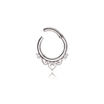 The Kaya Movement's Minimalist Mandala-Inspired Septum in 316L Steel Silver Look "Zura" showcases an intricate design with small loops and a central heart shape. This silver septum ring, available in 1.2mm gauge and diameters of 6mm, 8mm, or 10mm, is open at the top for easy insertion and removal. Against a plain white background, this minimalist jewelry piece truly stands out.
