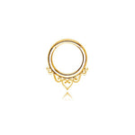 The Minimalist Mandala-Inspired Septum in 316L Steel PVD Gold "Zura" by Kaya Movement showcases a beautifully intricate heart and swirl design at the bottom. This circular septum ring, available in 1.2mm gauge and diameters of 6mm, 8mm, and 10mm, features delicate detailing that adds an elegant touch to the jewelry piece. Set against a white background, it perfectly captures the mandala-inspired charm.