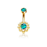 A stunning piece of Kaya Movement's Bohal Navel Jewelry, this Boho Essence gold barbell design features circular abalone shell inlays with vibrant blue-green patterns on the top and bottom ends. Crafted with 316L surgical steel, the bottom end boasts a decorative halo of small gold balls, perfectly blending natural and bohemian elegance.
