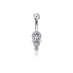 The Xale 1.6mm Navel Piercing by Kaya Movement boasts a brilliant gold finish and features a curved barbell adorned with four sparkling zircons in decreasing sizes, vertically aligned. Perfect for boho jewelry lovers, the top zircon attaches to the barbell while the other three form a drop-like design hanging below.