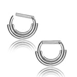 A pair of premium surgical steel septum rings designed with a unique triple-stacked pattern by Kaya Movement. These hypoallergenic and lightweight rings exhibit a clean and polished finish, subtly reflecting their elegance against a white background.