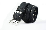 The ITO Punk Rock Men's Black Studded Leather Belt from Kaya Movement features a custom wasteland buckle. This black leather belt showcases metal rivet detailing and circular eyelets along its length, giving it an industrial punk rock appearance. The plain white background enhances the prominence of the belt in the image.