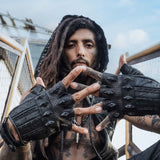 DZALA — black leather fingerless gloves with studs and red accents.