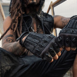 DZALA — black leather fingerless gloves with studs and red accents.