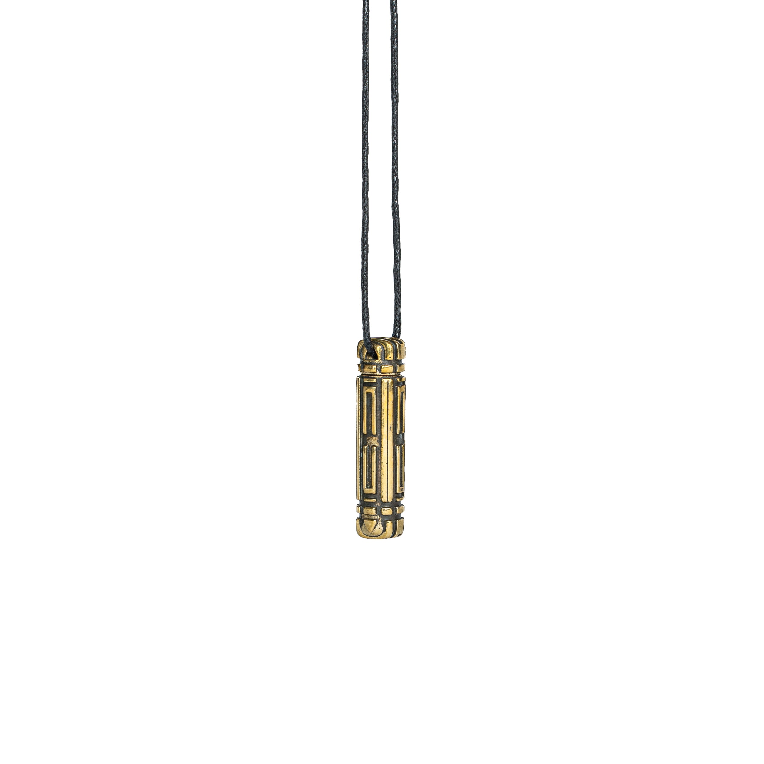 A brass Arcan Box pendant, hanging against a white background, displaying its bold and futuristic structure.