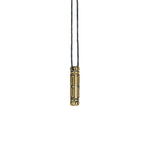 A brass Arcan Box pendant, hanging against a white background, displaying its bold and futuristic structure.